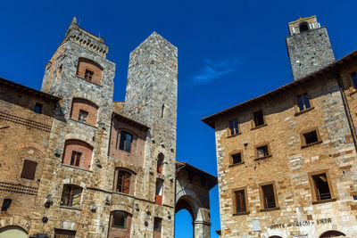 Low angle view of historic building against blue sky