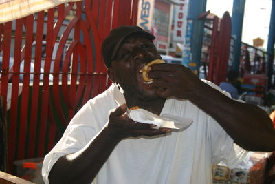 Portrait of man trini doubles while standing outdoors