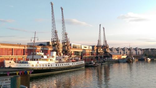 Boats in river with buildings in background