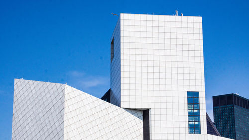 Low angle view of modern building against blue sky