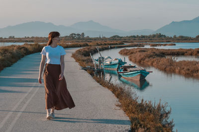 Rear view of woman standing at beach