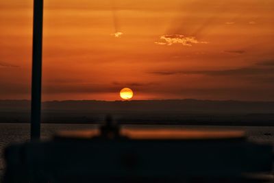 Scenic view of sea against orange sky