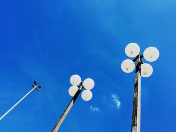 Low angle view of lamp post against blue sky