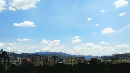 Buildings against cloudy sky