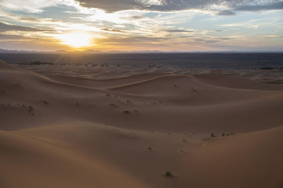 Scenic view of desert against sky during sunset