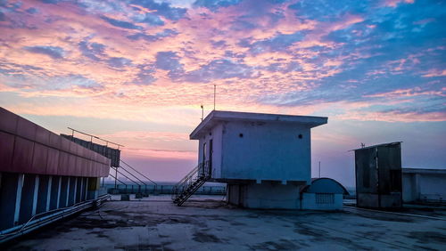 Built structure against cloudy sky during sunset