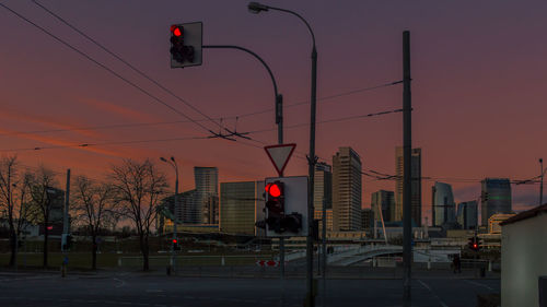 City street against sky during sunset