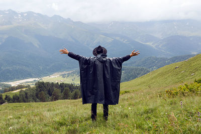 Rear view of man standing on mountain