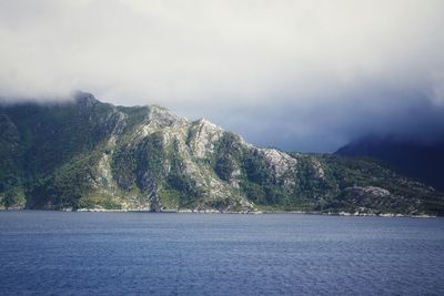 Scenic view of sea and mountains against sky