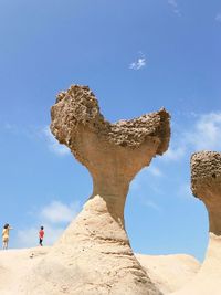 Low angle view of rock formations against sky