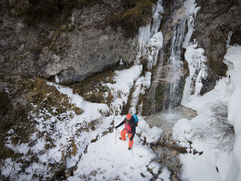 High angle view of man walking on snowcapped land