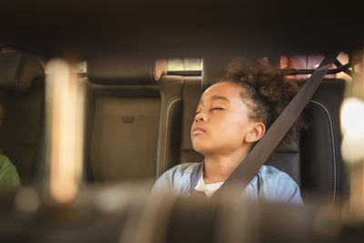 Tired girl sleeping in electric car