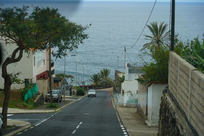 Road by sea against sky in city