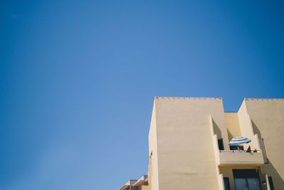 Low angle view of building against clear blue sky