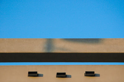 Low angle view of building against clear blue sky