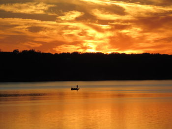 Scenic view of sea against orange sky