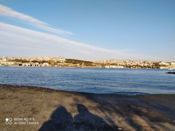 Scenic view of sea and buildings against sky