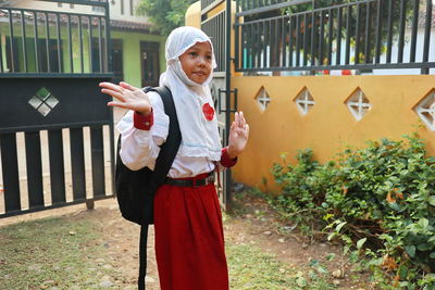 Girl wearing hijab standing on land