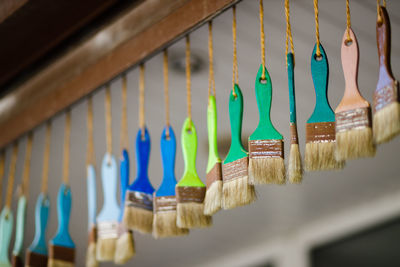 Close-up of clothespins hanging on wall