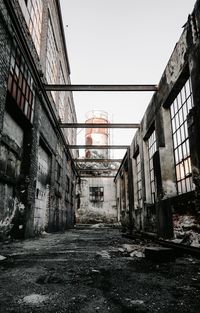 Abandoned building in city against clear sky