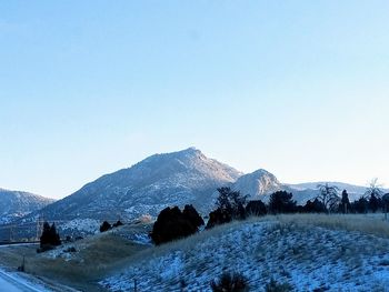 Scenic view of snowcapped mountains against clear sky