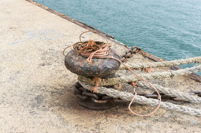 High angle view of rope tied on rock