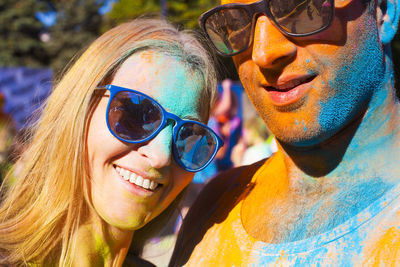 Portrait of smiling young woman wearing sunglasses