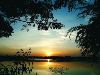 Scenic view of lake against sky during sunset