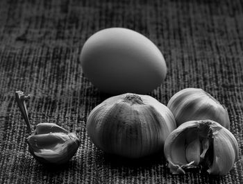 Close-up of egg and garlics on textile