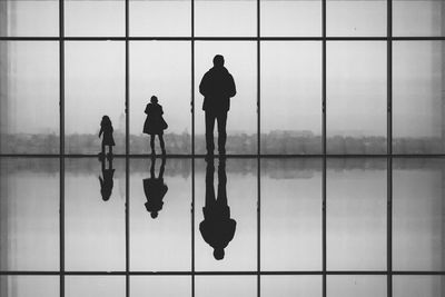 Low angle view of people standing by window