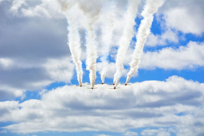 Low angle view of airshow against sky