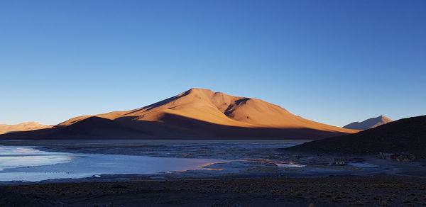 Scenic view of mountain against clear blue sky