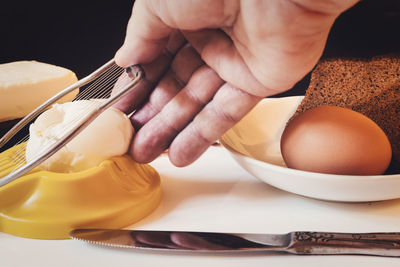 Cropped hand of person preparing food