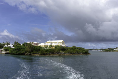 Building by sea against sky