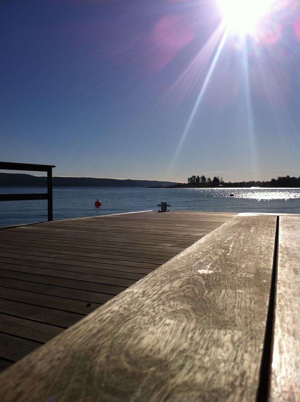 sun, water, sunlight, sunbeam, sky, sea, lens flare, tranquility, tranquil scene, scenics, built structure, nature, beauty in nature, transportation, reflection, outdoors, blue, horizon over water, architecture, sunny