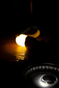 Close-up of lit candle in dark