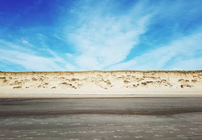 Scenic view of desert against blue sky