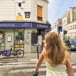 Rear view of woman on bicycle in city