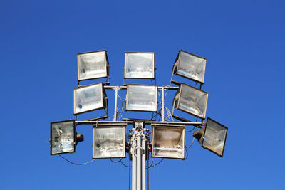 Group of lamps for stadium lighting, on the blue sky background.