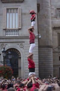 Group of people against building