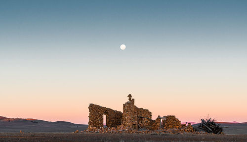 Built structure against clear sky at sunset