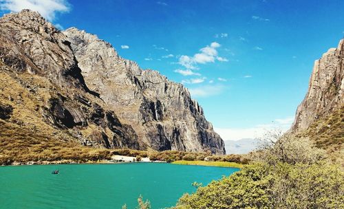 Panoramic view of sea and mountains against blue sky