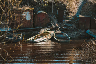 Abandoned boat moored in lake