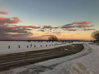 Scenic view of land against sky during sunset