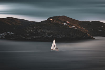 Sailboat sailing on sea against sky