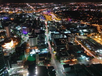 High angle view of city lit up at night