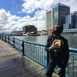 Woman standing by river in city