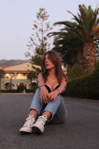 Melancholic young woman sitting down.