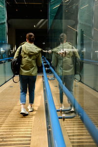 Rear view of man standing in factory
