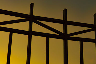 Full frame shot of metallic structure against sky during sunset